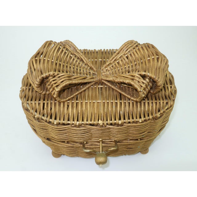 It's all wrapped up with a bow! Vintage antiqued gold wicker basket box with an adorable bow topper, wood ball feet and...