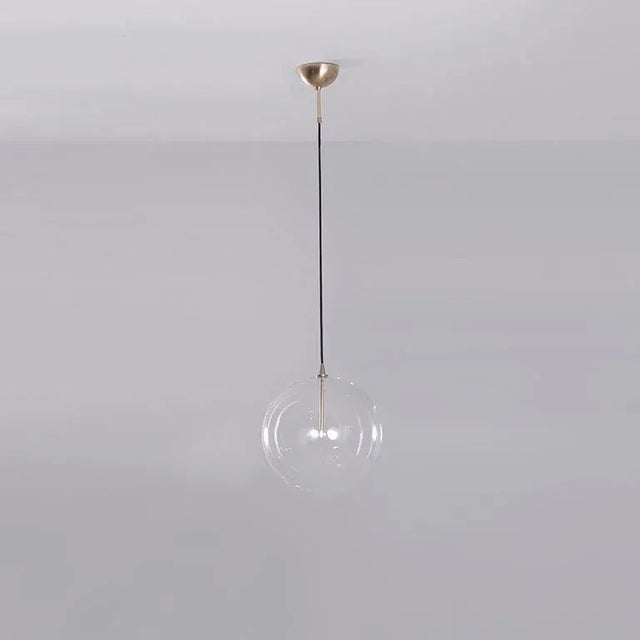 Glass globe 35 pendant light by schwung dimensions: w 35 x d 35 x h 354 cm materials: natural brass, hand blown glass...