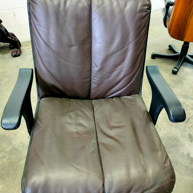 Swivel armchairs with solid wood frames and genuine brown leather upholstery, made in Italy in the 1960s. Dimensions:...