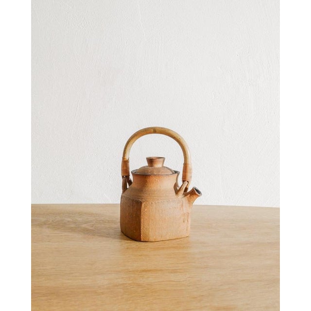 A very rare and unique decorative swedish mid century stoneware tea pot with a bamboo and rattan handle by signe persson-...