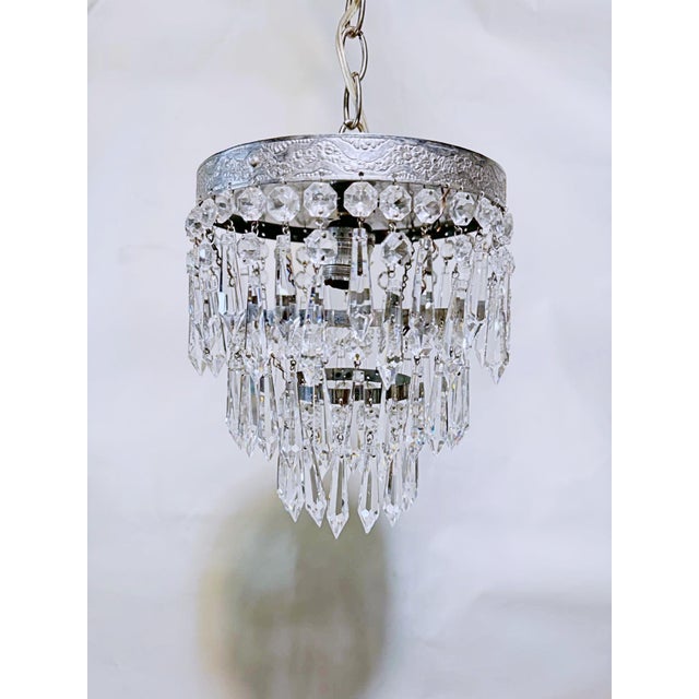 A striking combination of vintage sophistication and sparkling elegance, this beautiful crystal chandelier is a true...