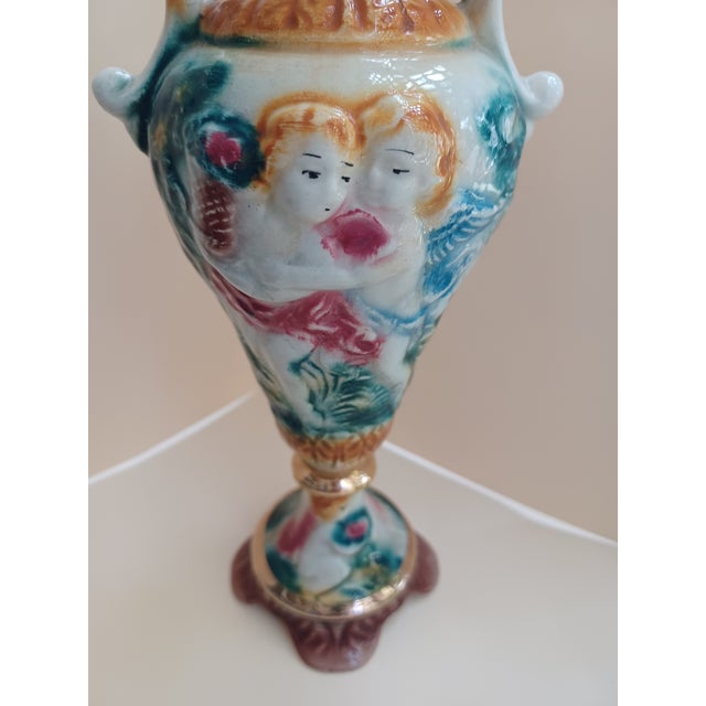 Gorgeous Vintage Italian Capodimonte double handle porcelain vase decorated in relief with various putti scenes. Signed...