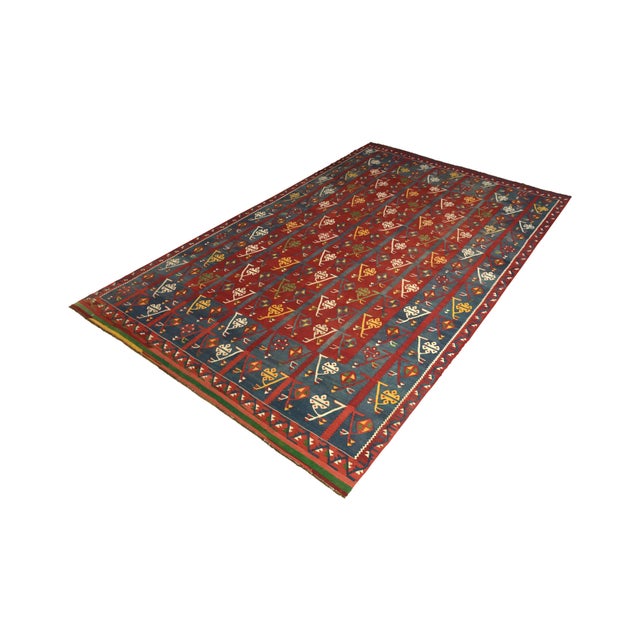 Handwoven in a wool flat weave originating from Turkey circa 1920-1930, this antique rug is a traditional Kilim rug...