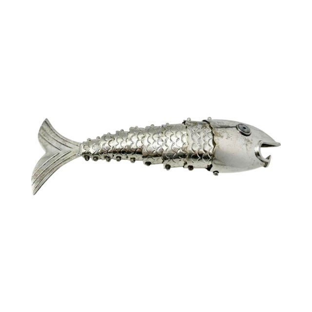 Articulated fish bottle opener is executed in metal with a segmented body that moves subtly in hand. The surface is...