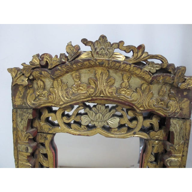 Divine Chinese, 19th century wall mirror. Extensive, ornate carvings of lotus flowers, foliage, and decorative motifs in...