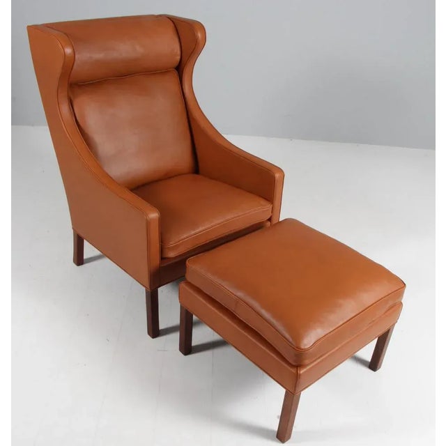 Børge Mogensen wingback chair with ottoman new upholstered with walnut elegance leather. Legs in teak. Model 2204, made by...