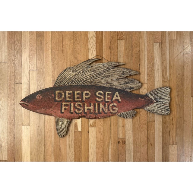 Vintage handmade "Deep Sea Fishing" wood sign featuring a fish-shaped silhouette with hand painted lettering, textured...