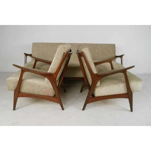 Stylish three-piece Danish modern living room suite with sofa or daybed and two armchairs. Nicely crafted teak frames and...