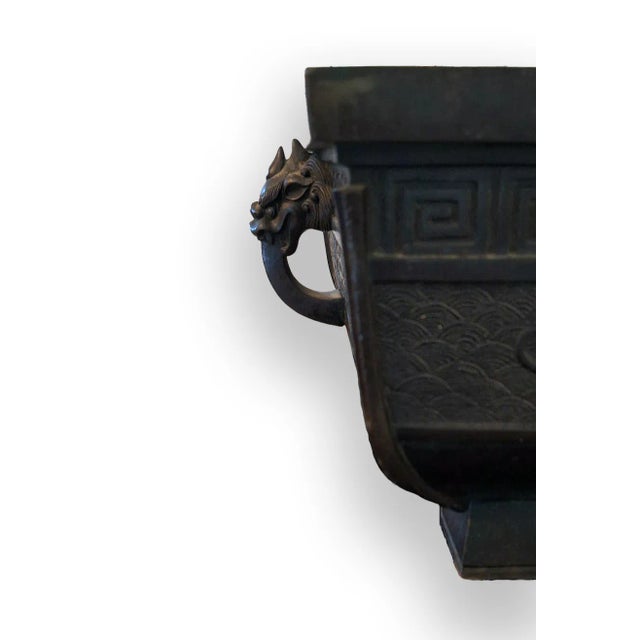 This exquisite antique Japanese bronze bonsai planter features captivating designs of dragons and stylized waves,...