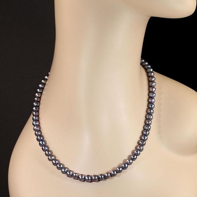 This stunning 18‑inch necklace features luminous peacock pearls measuring approximately 6–6.5 mm, each one showcasing a...