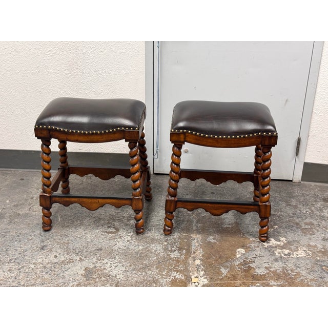 Design Plus Gallery presents a Pair of Barley Twist Leather Stools by Ambella Home Collection. Each stool has a padded...