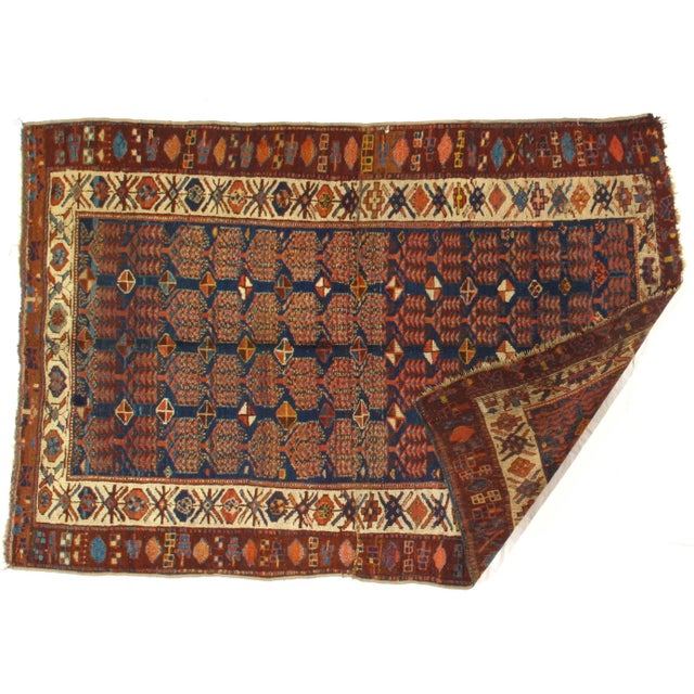 This is an antique Persian rug from the early 20th century. The piece was hand-woven using hand-spun and vegetable dyed...