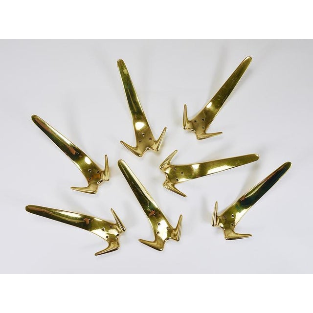 Up to seven Minimalist wall coat hooks, model #4056, designed and executed in the 1950s by Carl Aubock workshop,...