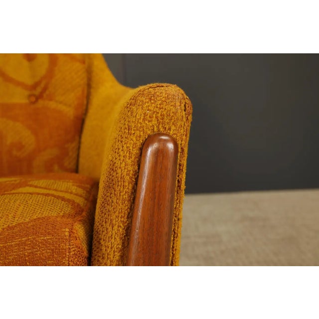 This 1960s vintage highback lounge chair features sculptural wood and groovy original 1960s fabric. The style is in the...