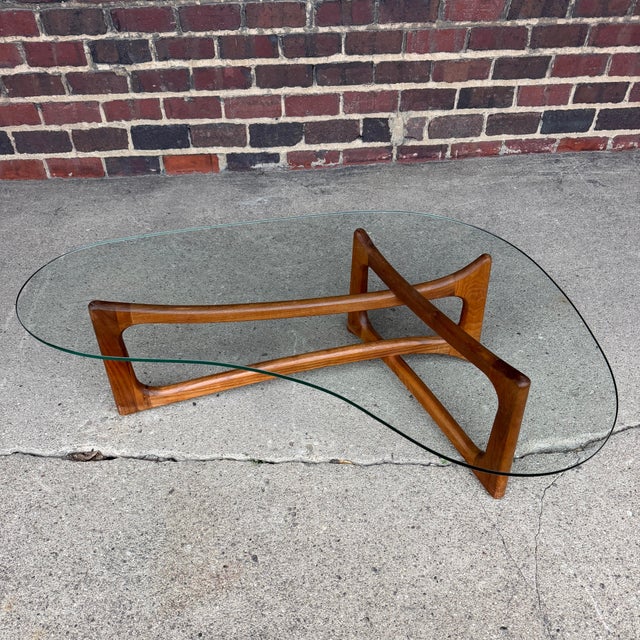 This Adrian Pearsall curved coffee table is a beautiful icon of mid-century modern design. The base is an asymmetrical X...