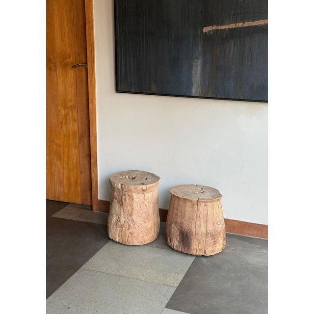 A beautifully aged antique teak side table originating from Java, Indonesia, distinguished by its sculptural simplicity...