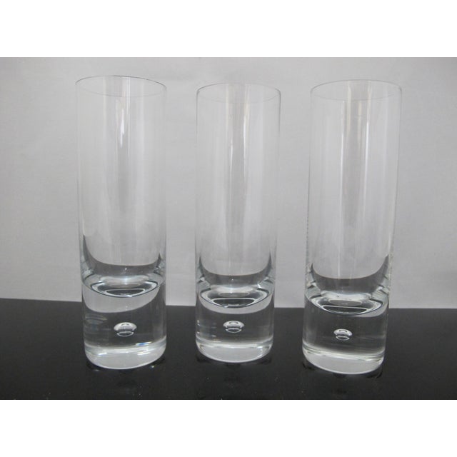 Sleek Kosta Boda, mid century modern style 'Pippi' skinny tumbler glass set of 3. Clear glass with single suspended air...