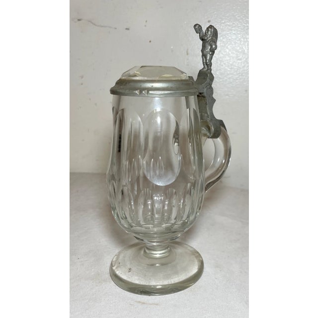 Up for sale is a rare antique 19th century lidded clear glass German beer stein. It's made into an exquisitely rare footed...