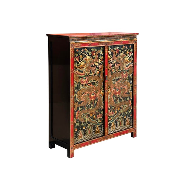 Embrace the captivating artistry of this hand-painted Tibetan cabinet, a striking statement piece adorned with powerful...