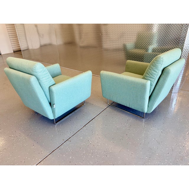 A pair of modern turquoise flight lounge chairs by Mario Bellini. Great pair of chairs that are very comfortable to sit...