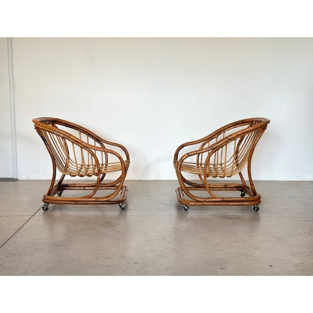 Pair of 1970s rattan and bamboo armchairs, frame on wheels, missing cushions