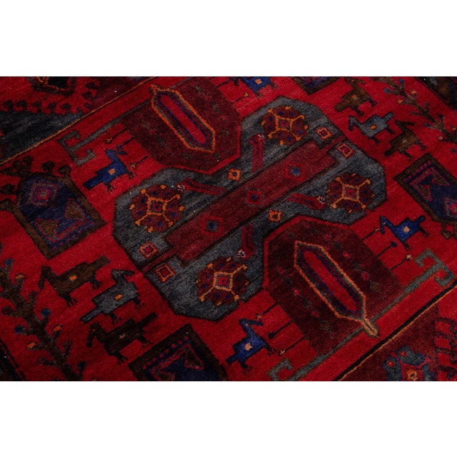 Beautiful vintage Bidjar hand-knotted wool rug with a red color field. This piece has a navy blue frame and multicolor...