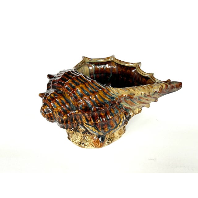 This vintage ceramic conch shell planter figurine is a dramatic piece of art pottery. Display the vintage ceramic seashell...