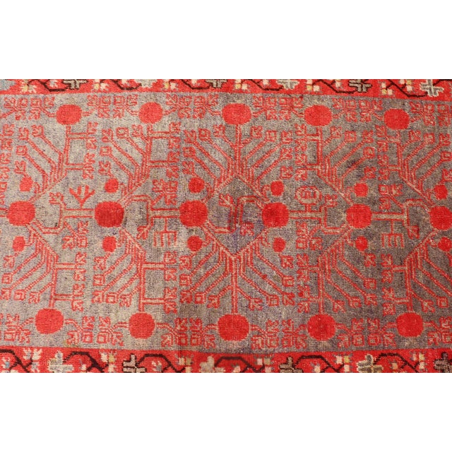 Measures: 3'10'' x 8'1''. This unique antique Khotan rug is a spectacular testament to the complexity of Turkestan design....