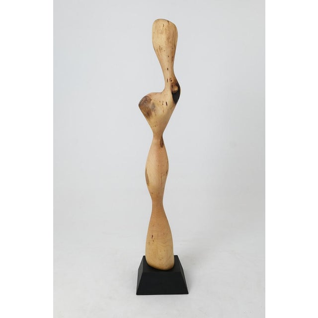 Carved from a single piece of wood, this tall abstract sculpture is a masterwork of organic fluidity. Its design features...