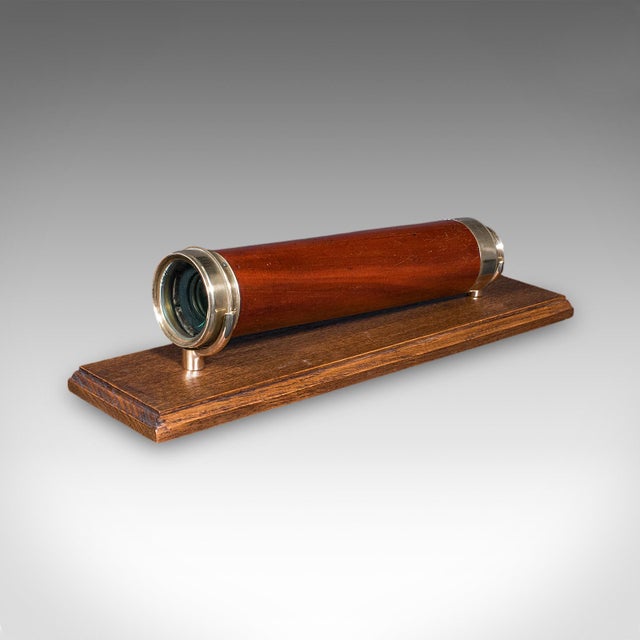 This is a large antique four draw telescope. An English, brass and mahogany terrestrial or maritime spyglass, dating to...
