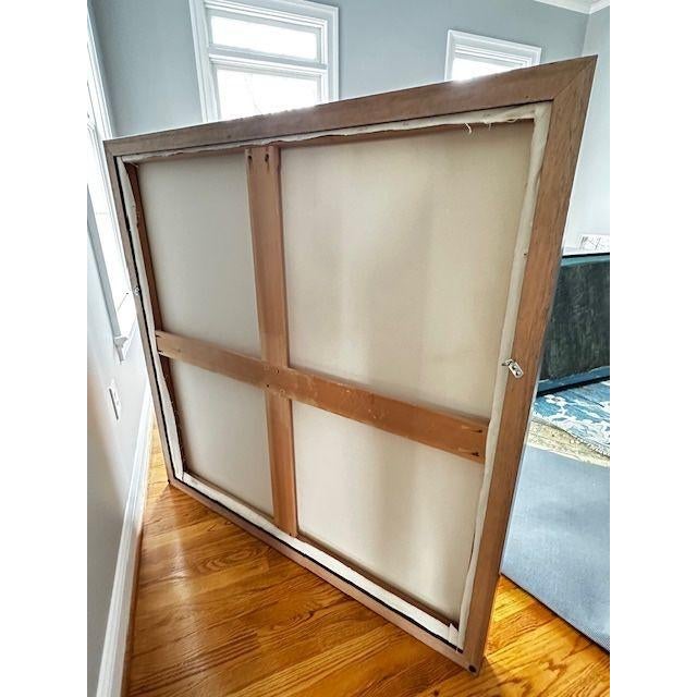 Striking large-scale artwork on framed canvas depicting a snowy winter landscape. In layered shades of icy blue, slate,...