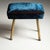 A pair of vintage stools with rectangular seats and four-leg bases made of brass. The stools have been reupholstered with...