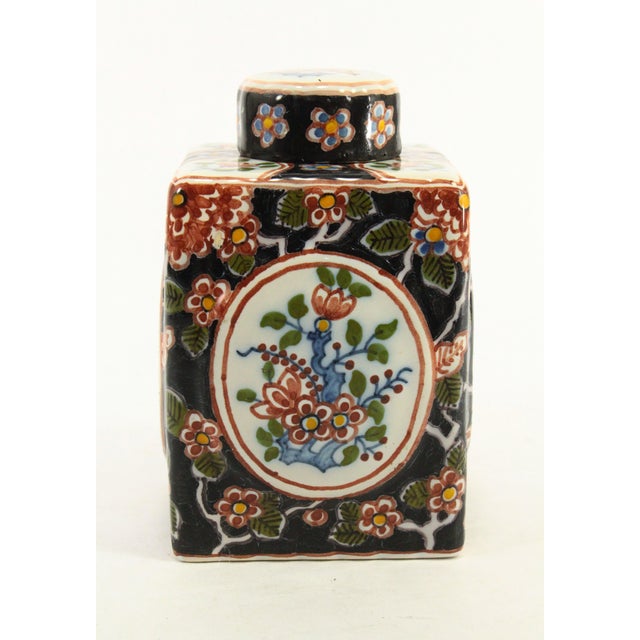 A beautiful faience tea caddy Square jar with lid in Chinoiserie taste resembling the Delft production from the 17th/18th...