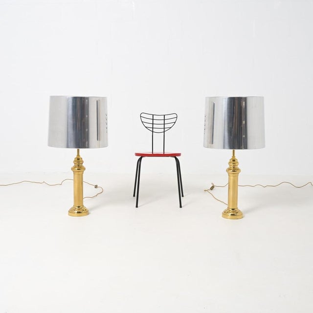 These stylish classic XL floor or table lamps date from the 1970s. The brass column base holds an aluminum lamp shade....