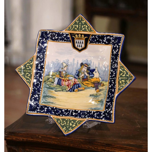 Crafted in France circa 1910, this unusual antique faience wall platter was made by Henriot Quimper and features a...