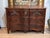 Early 18th C. French Provincial walnut commode with a shaped, molded top over a serpentine front. Three long drawers have...