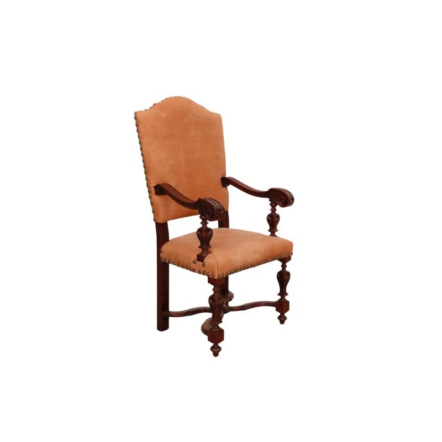 A Jacobean style leather chair dating from the late 1800's. Made of mahogany, the seat and back are upholstered in leather...