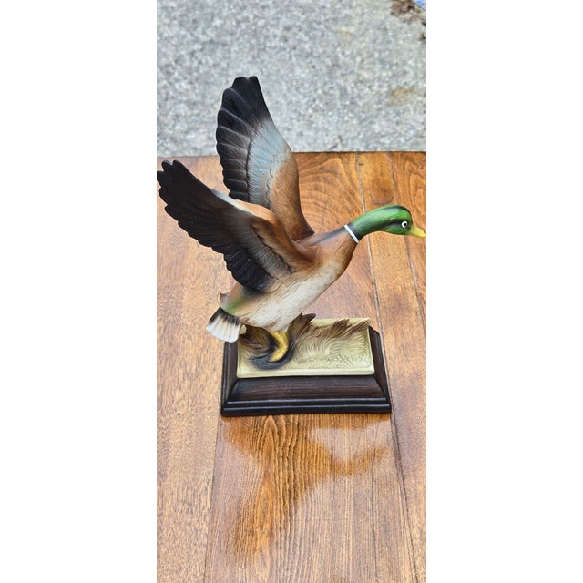 Striking decorative mallard duck sculpture featuring dramatically raised wings and a beautifully hand-painted finish. The...
