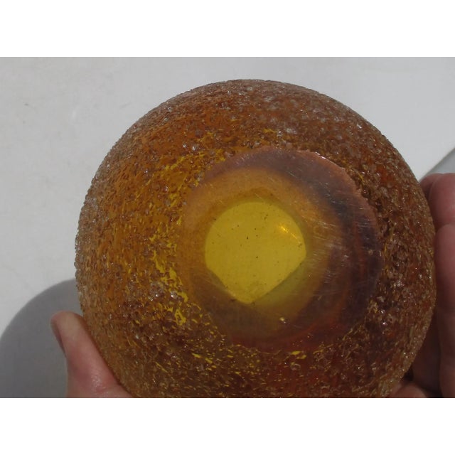 Studio Art Glass. Heavy-formed amber glass globe with a crushed glass-coated surface. Very thick walls with two layers of...