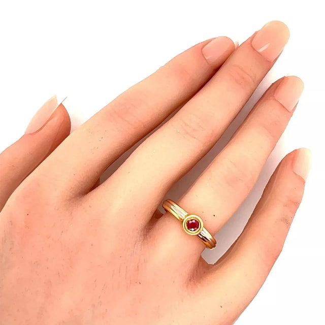 This authentic ring is by Cartier from the Trinity Collection. It is crafted from 18k yellow, rose and white gold with a...