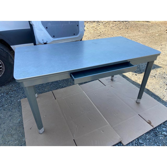Raymond Loewy metal Mcm for the general fireproofing company Tanker Desk Table is a unique and stylish piece of furniture...