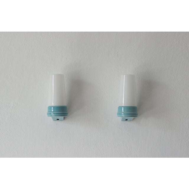 A pair of ceramic wall sconces designed by Sigvard Bernadotte for the Swedish manufacturer Ifö. The fixtures embody 1960s...