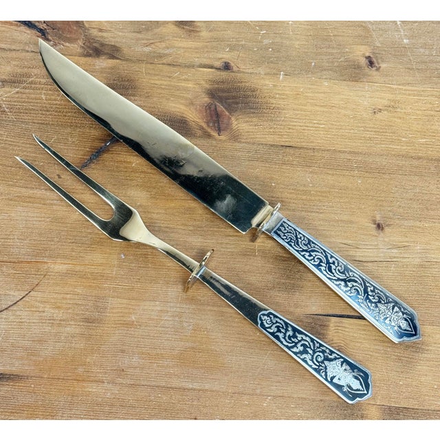 Vintage Siam bronzeware carving knife and fork set. Presented in a velvet-lined wood box. Knife: 13"L; fork: 11"L. Box:...