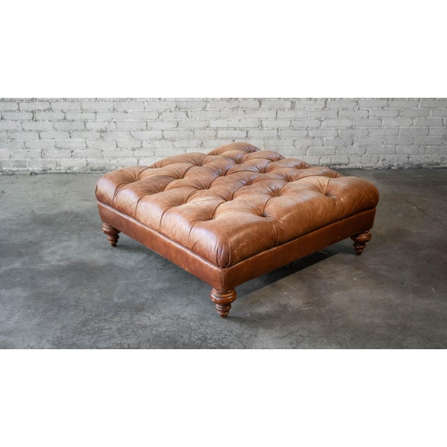 Thomasville tufted leather cocktail ottoman, circa 2001. Timeless Chesterfield design with button tufting and distressed...