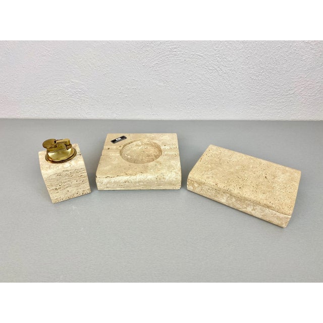 Tobacco set in travertine marble composed of ashtray, lighter and box by the Italian designer Cerri Nestore, 1970s. The...