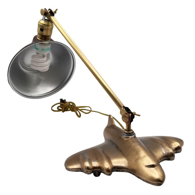 A rare Art Deco–inspired Sarsaparilla banker’s lamp featuring a sculptural Brass-tone jet-plane base and classic...