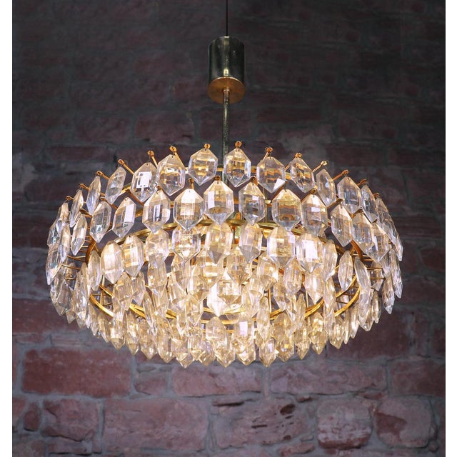 Elegant large and very impressive chandelier with faceted crystals on a brass frame. Manufactured by lobmeyr / bakalowits...