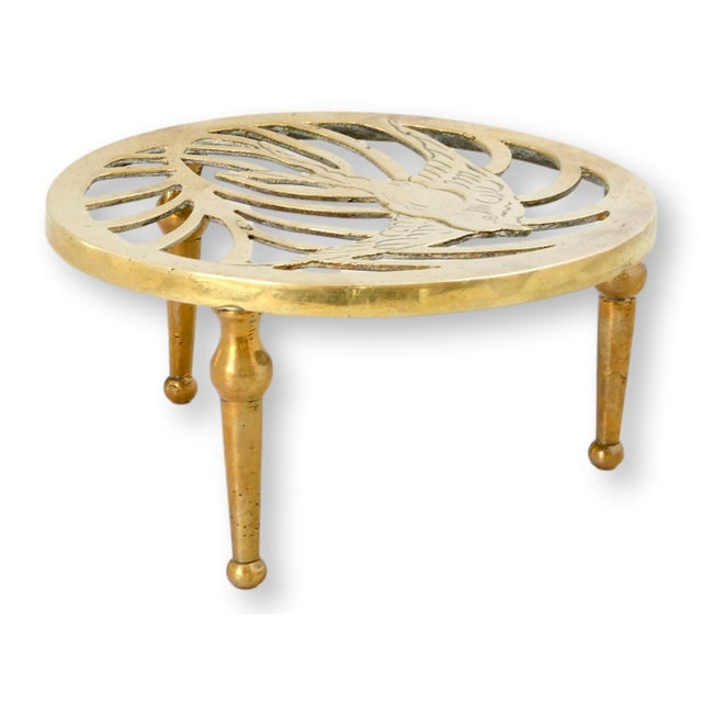 Late 19th century English brass trivet featuring a pierced bird motif within a radiating openwork design. Influenced by...
