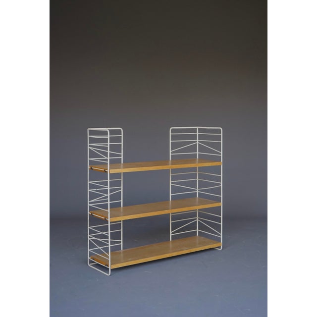 A rare small free-standing Swedish 1960s shelving unit. Adjustable shelves - It has beechwood veneered block board shelves...