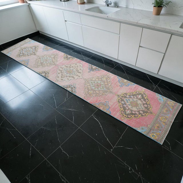 Woven in the celebrated workshops of Oushak during the 1970s, this authentic Turkish runner rug showcases a refined...